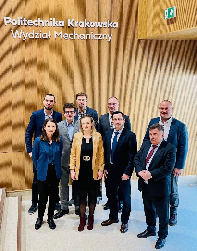 Pracownicy firmy Siemens Mobility wraz z pracownikami Wydziału Mechanicznego pozują do zdjęcia